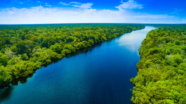 Boats navigating a river in the Amazon Rainforest